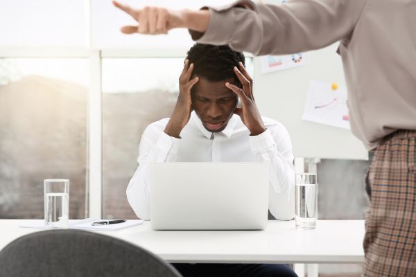 homme noir devant ordinateur face à des critiques discriminantes